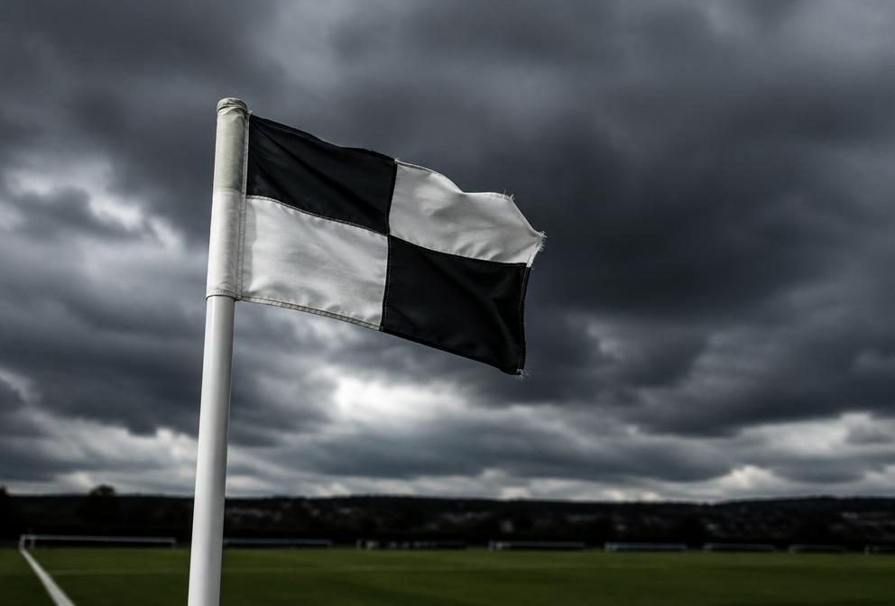 Corner flag against dark northern clouds